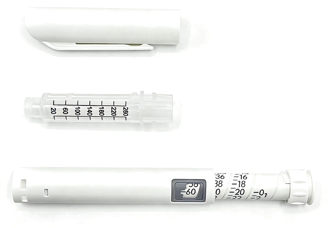 Reusable dosing pen shown with its cartridge and cap